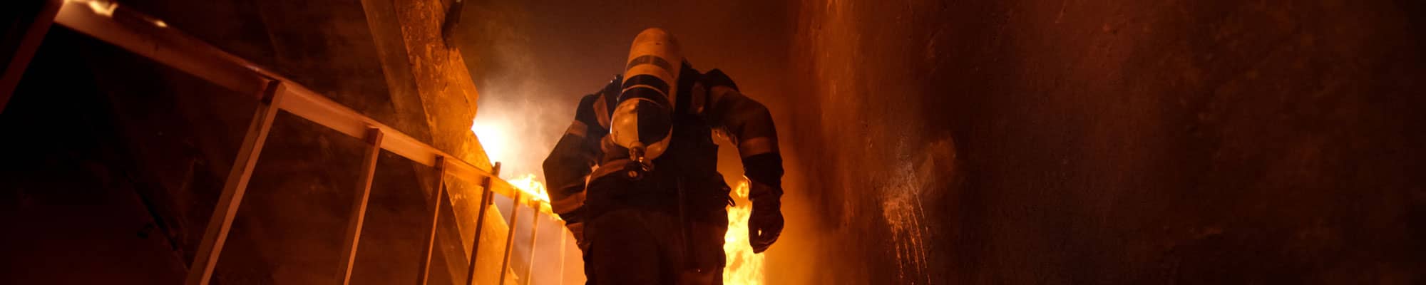 Firefighter walking up stairs at commercial premises in Chester